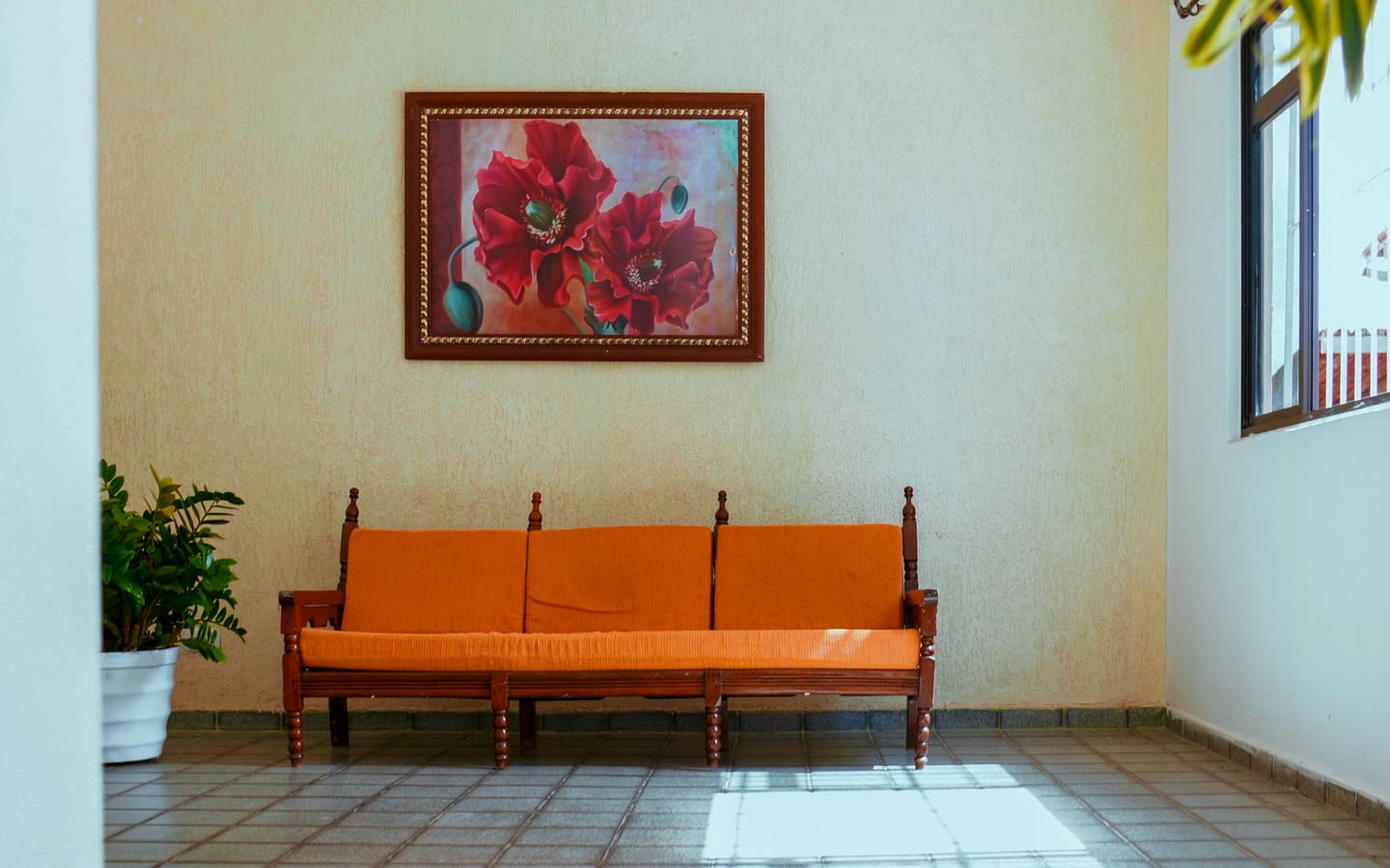 Sala de estar da clínica, com sofá e quadro na parede